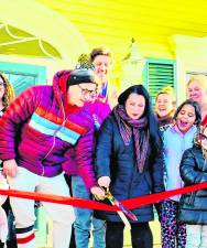 Laura Renee cuts the ribbon at the Jan. 17 grand opening of the Art Project in Sparta. (Photo provided)
