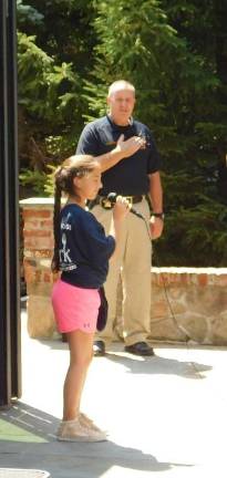 Sparta Junior Police Academy graduates 70 Cadet Romina Perry performs the Star-Spangled Banner to open the graduation ceremony of the Sparta Junior Police Academy on Friday, August 24, 2018, at the Mohawk House in Sparta. Deputy Smith of the Sussex County Sheriff's Office looks on Photos by Mandy Coriston, except where otherwise noted
