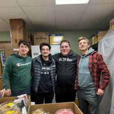 Volunteers Billy Karipides, Matt Onorato, Christian Macchio and Matt Attala help distribute holiday meals Wednesday, Dec. 13 at the Sparta Community Food Pantry. (Photos provided)