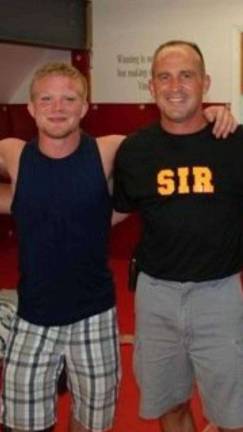Wrestler turned coach teaches hard work, discipline and pride Livingston with his mentor and SIR founder Shawn Hall