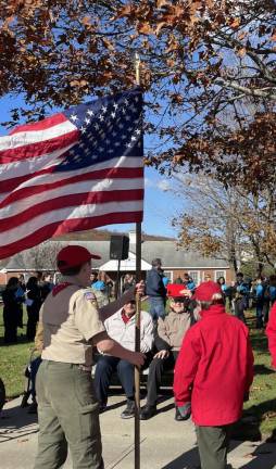 SV2 Veterans watch as Boy Scouts raise the flag during the ceremony.