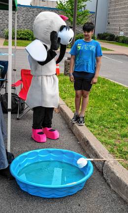 Photos: Earth Day Fair Varin Majalamotlg with a giant mosquito.