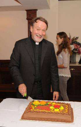 Beloved priest celebrates 30 years What's a celeration without some cake? PHOTO BY LAURIE GORDON