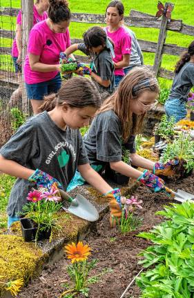Photos: Earth Day Fair Girl Scouts Brianna Davis and Amelia Towe plant flowers in the community garden during the Earth Day Fair on Saturday, May 3 at Sparta Middle School. (Photos by Nancy Madacsi)
