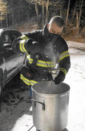 Ogdensburg firefighter Earl Hornyak serves chicken noodle soup (Photo by Vera Olinski)