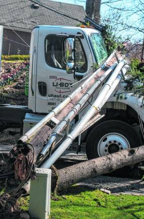 A driver was trapped inside a truck for about 45 minutes after striking an electrical pole and pine tree Thursday, March 14 on Shady Lane in Lake Mohawk. (Photos by Nancy Madacsi)