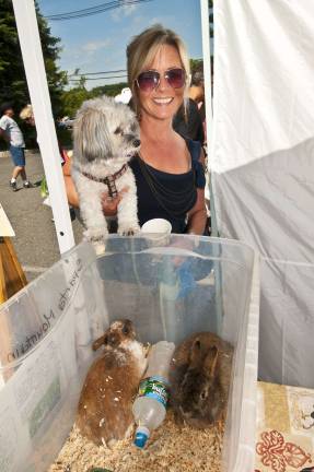 Local sunshine Photos by Warren Westura Terry Meshan of Sparta and her pooch Havenese check out the rabbits at the Sparta Farmers Market.