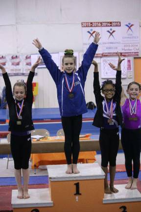 Sparta club gymnasts excel Fiona Postas, State Champion All Around for Gold Xcel, age 9.