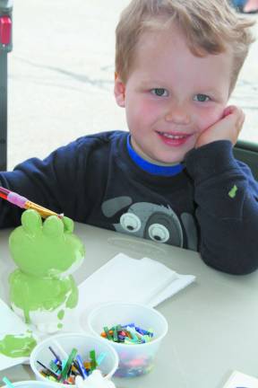 Bounce houses, face painting and more at Sparta Day David Baszczji of Sparta painting a ceramic frog.