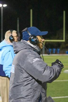 Coaches keep a watchful eye over game play.