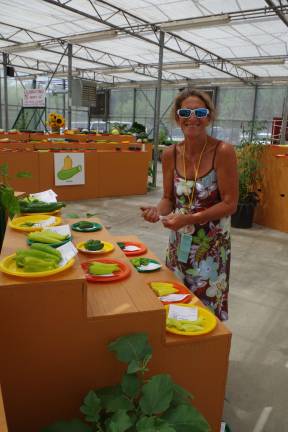 Fair fun Vegetable competition director Shawna Bengivenni of Wantage is shown summarizing the ratings given by the three judges.