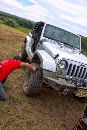 Wheelers for the Wounded trail ride Paul Cooke of Butler checks tires after ride
