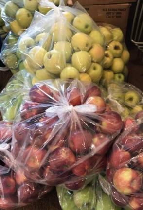 Apples donated by John Mathews, of Hinkley Auto Sales, and Project Self-Sufficiency volunteer Stephanie Supman