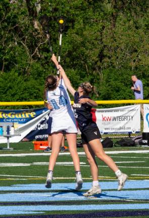 Vernon midfielder Sidney Tassel (15) catches the ball before Spartan midfielder Aine Byrne (14) after an opening draw.