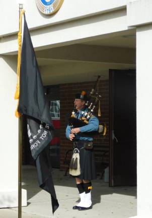 Newton Police Department Special Officer Steve Moran plays the bagpipes as part of the Flags of Honor ceremony at the Newton Municipal Building on Saturday, Nov. 9, 2019.