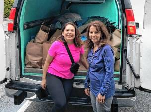 Estrella Rosenberg, left, and Jane Birnbaum bring used prom dresses to Project Self-Sufficiency in Newton. (Photo provided)