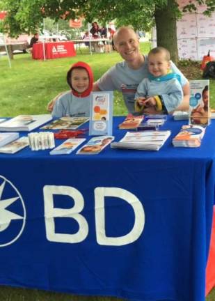 Chris Gildea, with his sons, volunteering at an American Diabetes Association event. Photo provided by Katie Gildea.