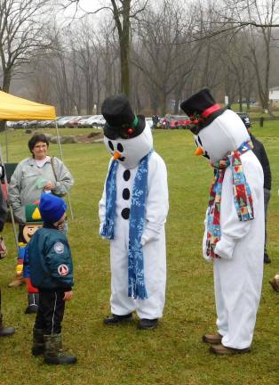 Snowmen greet a child at Sparta's Christmas Festival on Sunday Dec. 2, 2018 in Station Park.&#xa0;(Photo by Mandy Coriston).