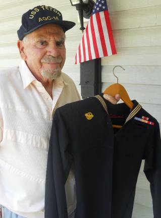 Sparta Navy veteran had front row seats to history Photo by Alexis Tarrazi Art Williams holding his Navy uniform in front of his Sparta home.