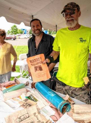 Photos: 80th birthday party James Kimble and Ron Constable with a flier from the 1969 Woodstock Music and Art Fair found in the time capsule.