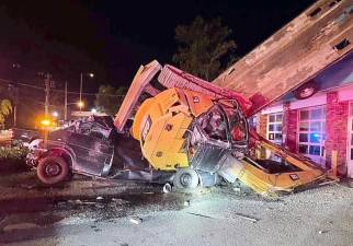 Pickup truck with excavator slams into Sparta business