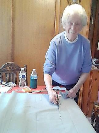 Vernon Township Woman’s Club member Barbara Fimia cuts fabric for pillows that she will sew and donate to Newton Memorial Hospital.