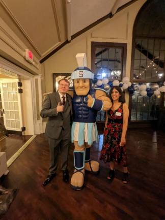 Callum McAuley, who was the SHS mascot in 2011, poses with Julie Patel and Sparty.