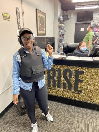 Maliuqka Burton, 46, a nurse who lives in Newburgh, N.Y., at an indoor gun range with other members of the Hudson Valley Nubian Gun Club. She wants a handgun to protect herself on her way to the hospital at 3 a.m. (Photo by Damon Finch)