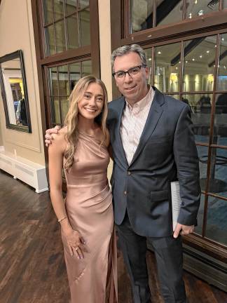 Sparta. Pope John Scholar Athlete Katy Miller, a senior soccer and track and field athlete at Pope John XXIII Regional High School, is named a 2025 Pass it Along Scholar Athlete at the annual Sussex County Scholar Athlete Banquet. Posing with her is Pope John’s track and field coach Brian Corcoran. Miller and 12 other student athletes each were awarded a $1,000 college scholarship in recognition of their dedication and hard work. (Photo provided)