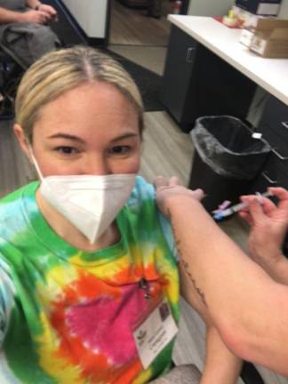 Milford, Pa. resident Sara Cohen, a home health care aid, takes a selfie while getting vaccinated. Photo provided.