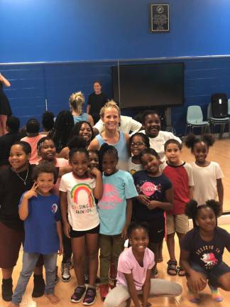 Evian, Hermione, Cailey, Amanda, Lyanna, Wynter, Autumn, Natalia, Aiden, Z’amaya, Annaiya, Tori, Adja. Kimora with their hip hop instructor, Christie Taylor, of Sparta, at Center Stage for Change. Christie Taylor has used skills she learned at Project Self-Sufficiency, to start Center Stage for Change in Harlem.