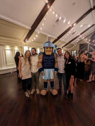 The Montesano twins, Gerard and Dante pose with their wives and Sparty.