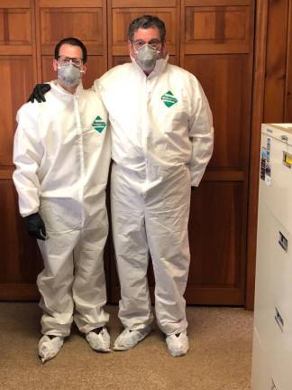 Aaron Tirpack, left, and Joe Clark preparing to handle the remains of someone who died of Covid-19. Tirpack lost 25 pounds during the pandemic; Clark ended up in the hospital thinking he was having a heart attack.