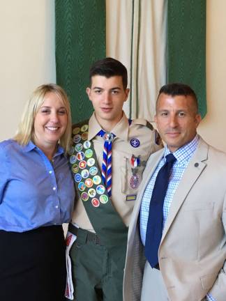 Scout earns Eagle rank Eagle Scout Gunner Nunn (center) of Andover Township, poses with his mother, Jacqueline, and his father, Michael, at his Eagle Court of Honor on August 28, at Blessed Kateri Tekakwitha Parish, in Sparta.
