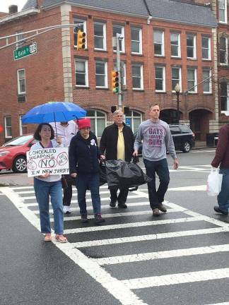 Members of the Sussex County Chapter of the Brady Campaign carry a &quot;body bag&quot; to Rep. Rodney Frelinghuysen's office in Morristown Photos courtesy of the Sussex County Chapter of the Brady Campaign