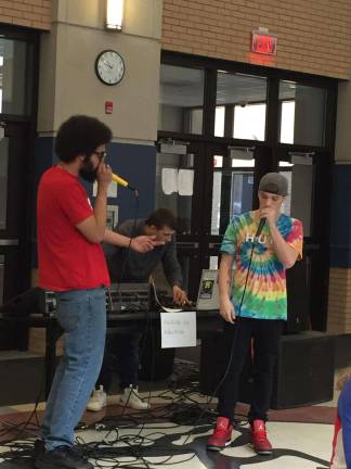 DJ battle benefit at Sparta HS Sparta High School Senior Kyle Romaine, right, performs with Honeycomb, left, and DJ Spencer Lavoie at the Amp the Vibe preview held at the high school last week.