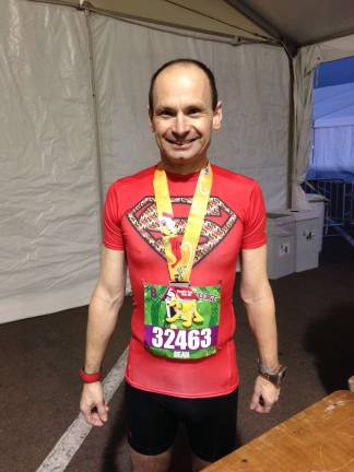 Marathon runner, Dean Giering, 47 of Newton sported a different superhero shirt for each race.