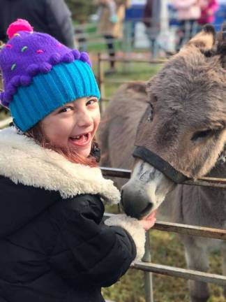 Lake Mohawk German Christmas Market 2018 Sienna Palumbo, 7, is very excited to feed the animals and ride the horses at the German Market this past weekend. (Photo provided).