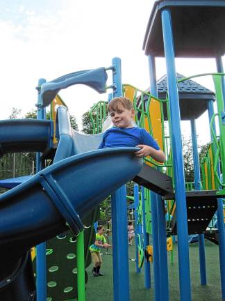 Inclusive playground opens CIP1 Aidan Heninger-Lowell, 7, goes down the slide at the new completely inclusive playground at C.O. Johnson Park in Byram. (Photo by Theresa Esposito)