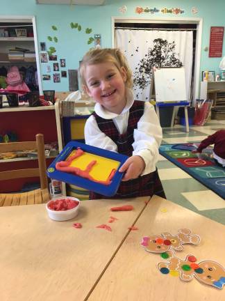 School offers Early Childhood Development Program Reverend Brown pre-kindergarten student Caroline Turner makes the letter "E" out of dough through "Learning without Tears," a developmental program that Early Childhood teacher Dana Krygoski implemented at Reverend Brown to better understand how 3-year-old students learn and what is the best way to teach them. Photo submitted