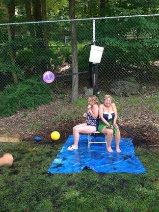 LMP owners Carol Carbin and Celia Leo under the Dunk Bucket