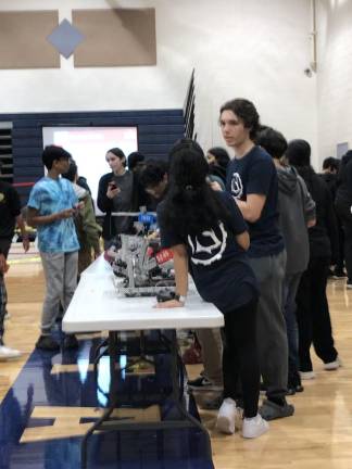 Teams line up their robots on a table before the final qualifiers begin.