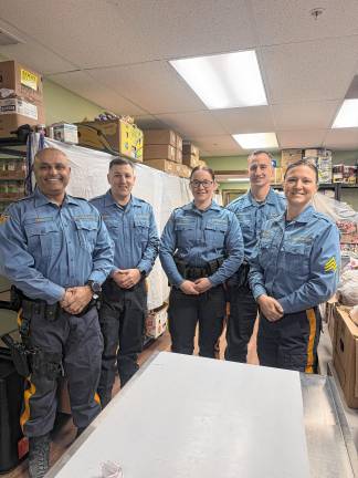 Community food pantry turns 40 FP3 State troopers help out at the Sparta Community Food Pantry. (Photo provided)
