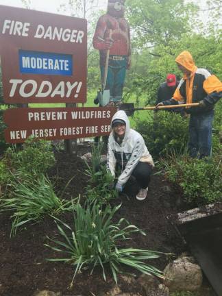 Downpours don't stop Thorlabs volunteers Kaylin Roth, an employee at Thorlabs, braved the elements on Saturday to volunteer for Pass It Along Day at Swartswood State Park. Photos by Laurie Gordon
