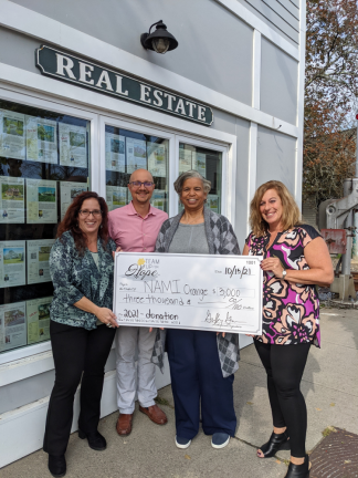 Keren Gonen, Geoff Green and Tiffany Megna of Team Up for Hope present the check to Sheila Sutton of NAMI Orange County. Photo provided by Team Up for Hope.