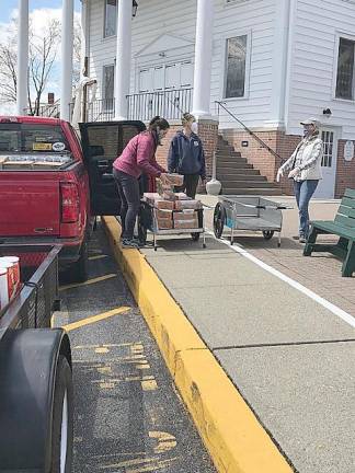 Volunteers with the Sparta Ecumenical Food Pantry distribute food (Photo provided)