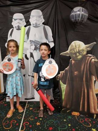 May the 4th Be with You Samantha and Nicholas Mammolo: Samantha and Nicholas pose with their lightsabers and BB-8s during the party.