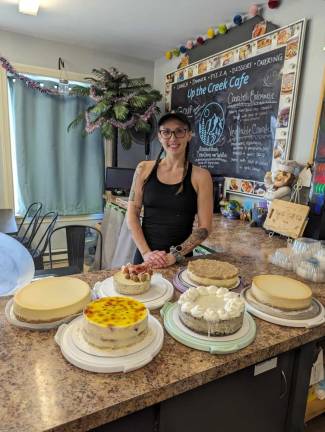 Kori Brown poses with some of her cheesecakes.