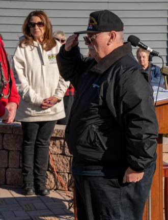 A man salutes during the ceremony.