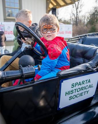 Carter Murphy, dressed as Spider-Man, sits in the Sparta Historical Society’s 1913 Ford Model T.